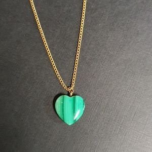 Gold tone chain with green striped heart pendant.